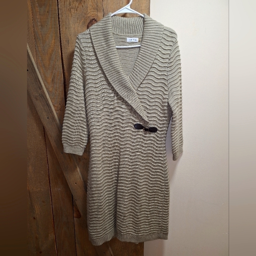 A Calvin Klein faux wrap ribbed knitted sweater dress in a ladies size medium.